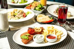 Table With Assorted Food and Beverage Plates photo