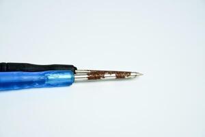Small rusty old and aged iron screwdriver repairing object isolated on horizontal ratio white background. photo