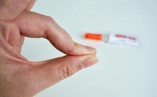 Human hand fingers glued together with strong adhesive super glue. Can not get super glue off the skin condition illustrative photography isolated on horizontal white background. photo