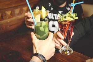 Group of People Sitting at a Table With Drinks, Enjoying a Social Gathering. photo