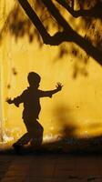 Playful Shadows such as a person creating hand shadow puppets against a wall or a child jumping photo