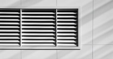 Ventilation Grille On White Facade Of Modern Building. Abstract Composition Of Shadows And Lines In Architecture. photo