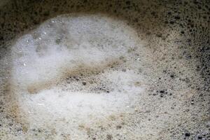 Boil malt grain in a pot in a home brewing process. Fermentation of grain for craft beer. Concept of home beer making photo