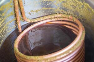 Close-up of a copper immersion heat exchanger which is used in the craft beer process. Selective focus. Process of home brewing photo