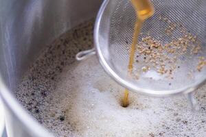 Close-up of craft beer and foam in fermentation container photo