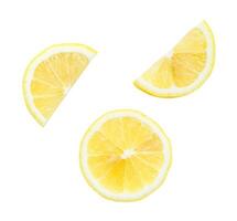 Top view set of fresh yellow lemon slices and halves scattering isolated on white background with clipping path photo
