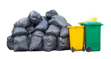 Front view of giant stack of garbage in black plastic bag with wheeled plastic bin or can isolated on white background with clipping path photo