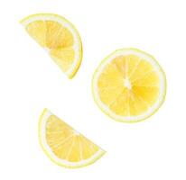 Top view set of fresh yellow lemon slices and halves scattering isolated on white background with clipping path photo