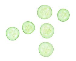 Top view set of green cucumber slices or pieces in circle shape scattering isolated on white background with clipping path photo