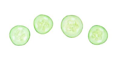 Top view set of fresh green cucumber slices or pieces scattering isolated on white background with clipping path photo
