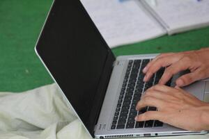 Close up image of Man hands typing on laptop computer keyboard, working, business and technology, internet network communication concept photo