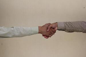 Close up two man shaking hand on white background.Athletes shaking hands before sports competition. Unity and teamwork concept. photo