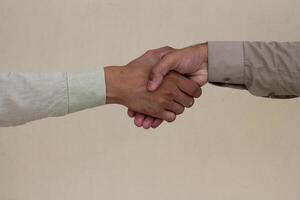 Close up two man shaking hand on white background.Athletes shaking hands before sports competition. Unity and teamwork concept. photo