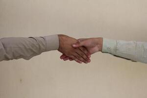 Close up two man shaking hand on white background.Athletes shaking hands before sports competition. Unity and teamwork concept. photo