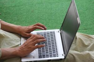 Close up image of Man hands typing on laptop computer keyboard, working, business and technology, internet network communication concept photo