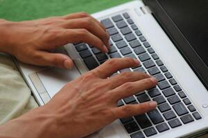 Close up image of Man hands typing on laptop computer keyboard, working, business and technology, internet network communication concept photo