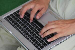 Close up image of Man hands typing on laptop computer keyboard, working, business and technology, internet network communication concept photo