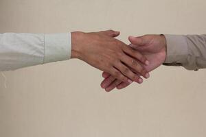Close up two man shaking hand on white background.Athletes shaking hands before sports competition. Unity and teamwork concept. photo