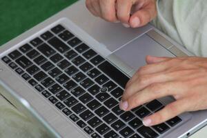 Close up image of Man hands typing on laptop computer keyboard, working, business and technology, internet network communication concept photo