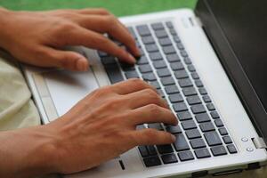 Close up image of Man hands typing on laptop computer keyboard, working, business and technology, internet network communication concept photo