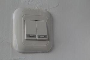 light switch with two buttons on a white wall photo