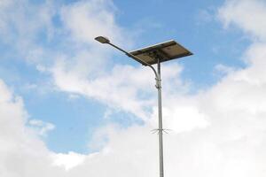 Blue Cloudy Sky and Street Lamp Minimalist Scene photo