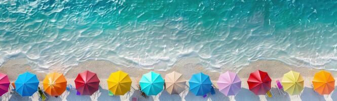Beautiful white beach with two rows of colorful parasols. photo