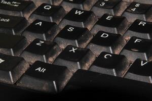 Close-Up View of a Dirty Computer Keyboard with Crumbs and Dust photo