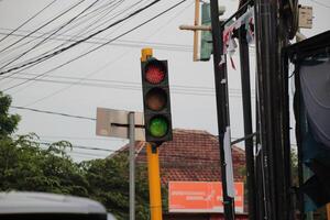 Traffic lights at urban intersection with electricity poles in the background photo