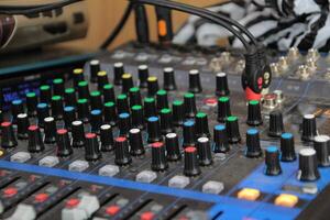 sound studio mixing desk stock photo, Audio music mixer console on a black background photo