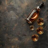 Whiskey with ice cubes in glass and bottle on table, space for text photo