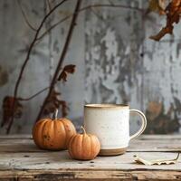 Mockup of a white coffee cup and pumpkin on an old wooden table against a background of beautiful autumn nature. Decoration for Halloween and Thanksgiving. Autumn still life, background or banner. photo