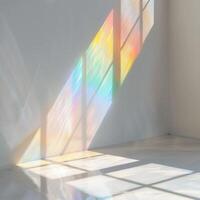 Mockup or photo design template with blurred rainbow light refraction texture overlay effect. Realistic organic natural light flash effects on a white wall.