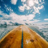 Surfboard against a clear blue sky. Breathtaking first-person view, dynamic footage of a surfer riding big waves along a tropical beach. photo
