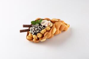 Hong kong or bubble waffle with ice cream and fruits isolated on white background photo