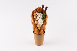 Hong kong or bubble waffle with ice cream and fruits isolated on white background photo