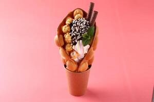 Hong kong or bubble waffle with ice cream and fruits isolated on white background photo