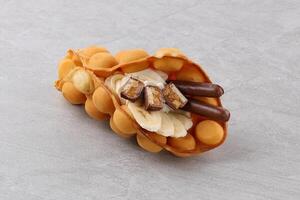 Hong kong or bubble waffle with ice cream and fruits isolated on white background photo