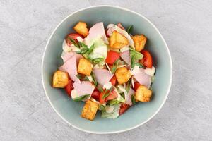 Salad with spinach, cheese, ham, grapefruit and balsamic sauce on a wooden rural background. Top view. Close-up. photo