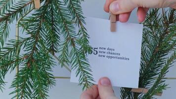Dream board with message 365 NEW DAYS CHANCES OPPORTUNITIES with fir branches. Happy new year resolutions concept. Visualizing creating vision board. Achievement setting goals video
