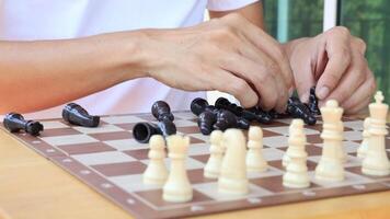 People playing chess at home and setting up the board with pieces for strategy planning and critical thinking on board game concept video