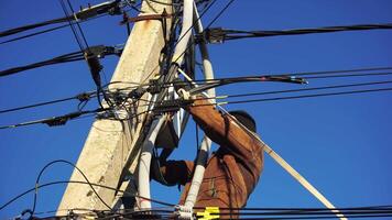 Close-up view of Electrician installing wires, cables into a electricity power shield, fuse box, an industrial electric panel with lots of colorful cables and wires. Power industry concept. video