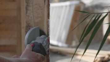 A man is using a power tool to cut wood. Concept of productivity and hard work. Slow motion video