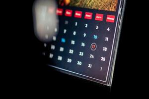 Close-up of a calendar page with dates and days of the week photo