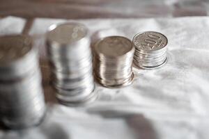 Stacks of Silver Coins on White Surface photo