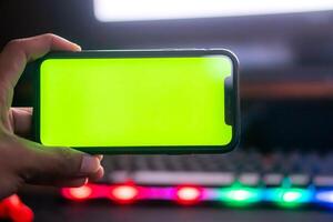 Smart phone with green screen and colorful keyboard photo