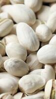 Closeup of pistachio nut seeds pattern texture background, macro pistachios nuts video