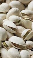 Closeup of pistachio nut seeds pattern texture background, macro pistachios nuts video