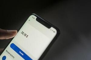 Smart phone displaying balance in financial app photo
