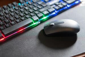 RGB Keyboard and Wireless Mouse on Mouse Pad photo